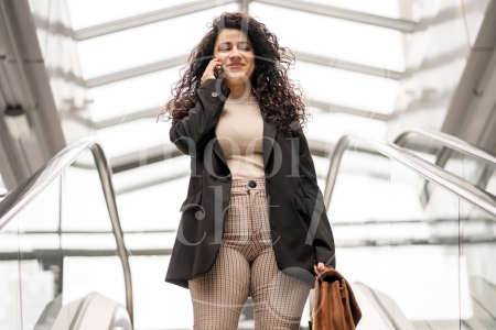 Vrouw aan het bellen op de roltrap 1